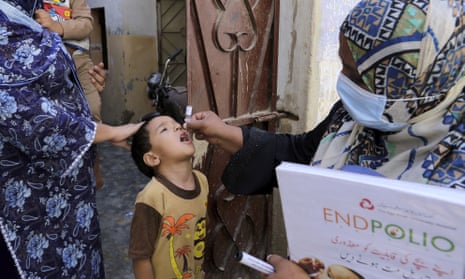 A health worker gives a polio vaccine to a child in Karachi, Pakistan, September 2020.