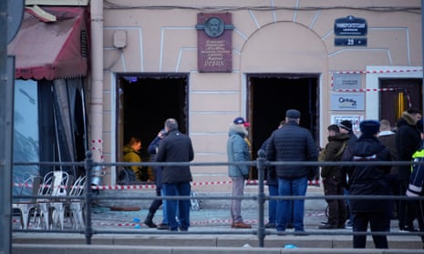 Russian investigators and police officers at the site of an explosion at a cafe in St Petersburg