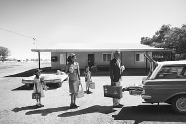 Livin’ the Dream (vacation) 2020, a monochrome photo of a 80s-styled family about to go on vacation, standing eerily behind a car with an open boot