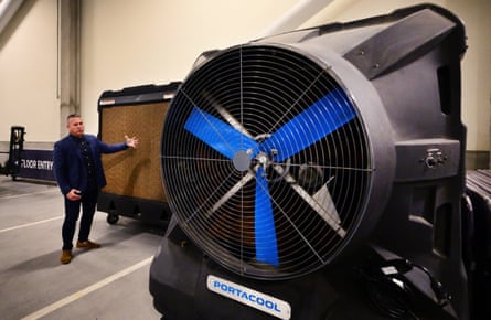 Otto Benedict, Senior vice-president, Facility and Campus Operations at SoFi Stadium gestures beside large fans, including the Portacool evaporative cooler, at the stadium in Inglewood, California, on 9 December 2025.