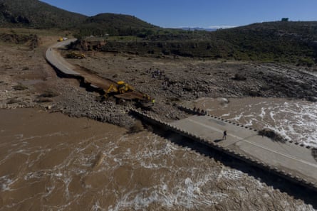 Workers repair a bridge damaged by flooding in Western Cape, South Africa.