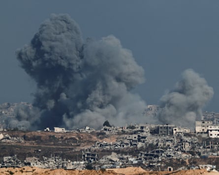 Ruined buildings with clouds of smoke behind
