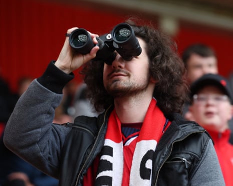 A Middlesbrough fan with a pair of binoculars