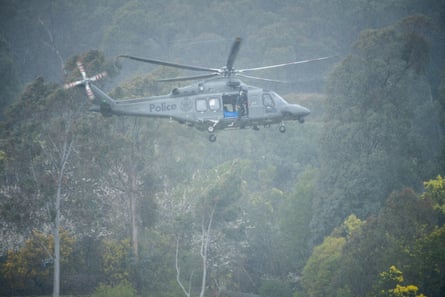A police helicopter lands at an operations centre just north of Porepunkah