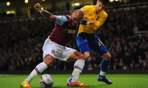 Julien Faubert, after returning to West Ham, battles with Adam Lallana.