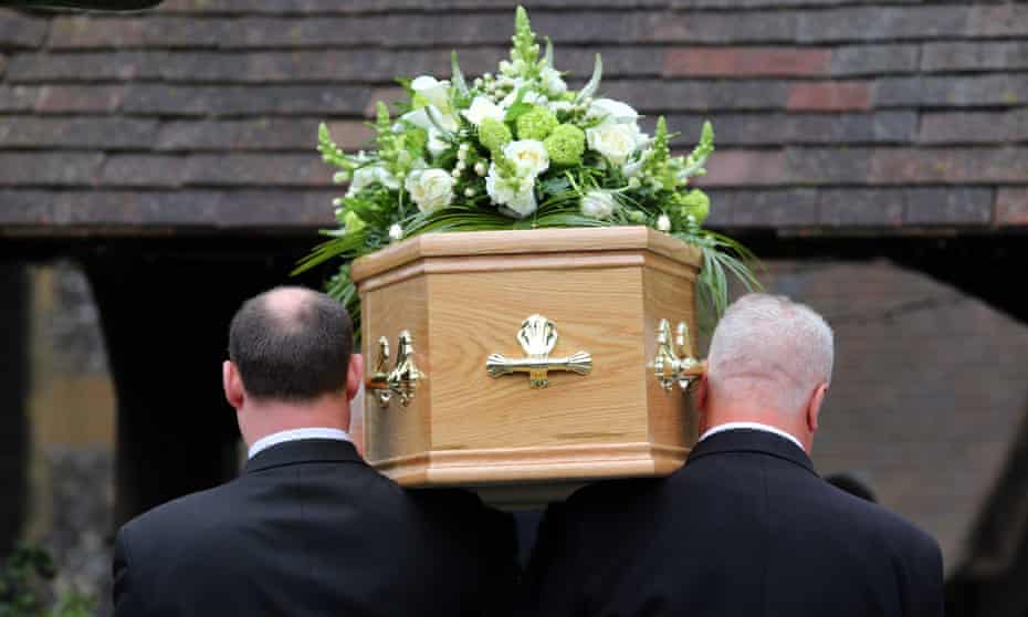Pallbearers carry a coffin on their shoulders