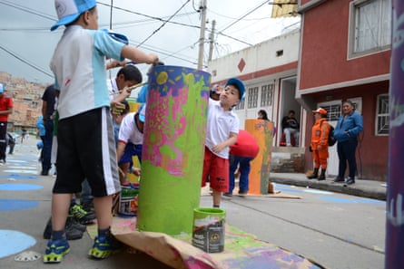 Children help brighten up a street in Bogotá