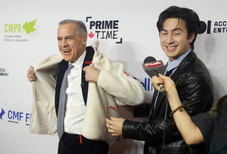 Carney pulls on the white fleece as Williams stands alongside