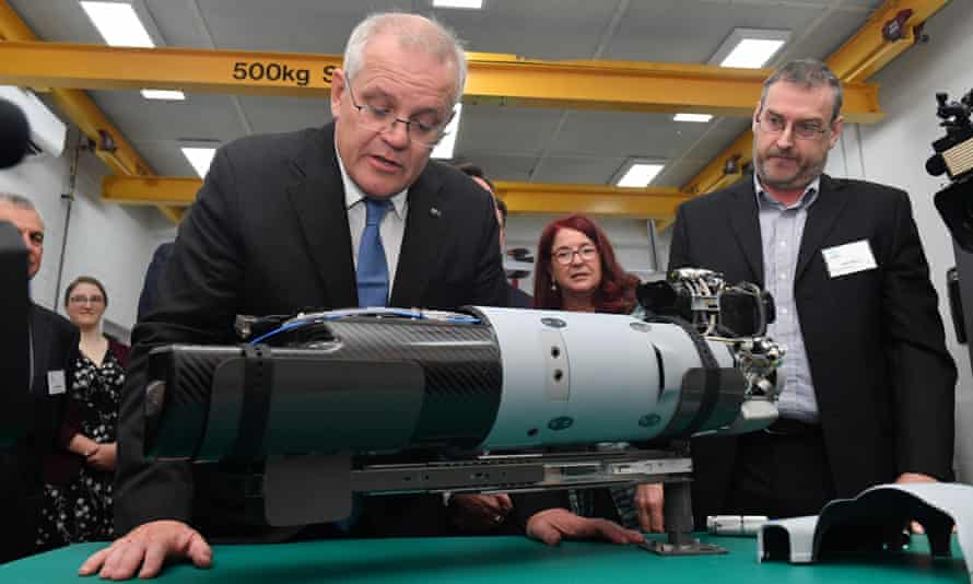 Scott Morrison examines a military drone engine during a campaign stop in Perth this morning
