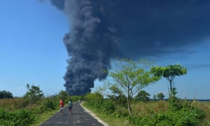 A plume of smoke rises following an explosion at an oil well operated by the state owned Oil India in Baghjan in the northeast Indian state of Assam