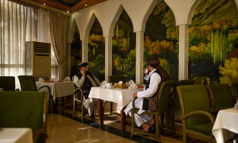 A manager and a Taliban government official in the dining room of the Intercontinental Hotel in Kabul.