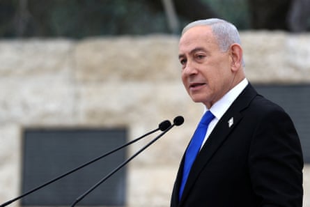 Benjamin Netanyahu speaking into two microphones