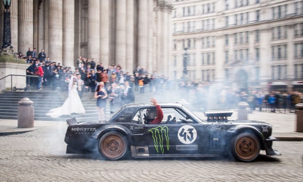 Matt LeBlanc waves to a bride and groom at St Paul’s cathedral in London as he and Ken Block drive past in controversial Top Gear filming. 
