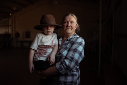 Resident Bev Smiles, 66, with her grand nephew, Will, 2, standing inside Wollar’s memorial hall, once a lively meeting place for the community in country NSW.