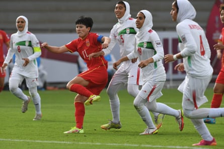 Iran players in action against China at the 2022 Asian Cup.