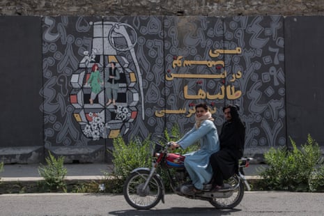 A mural in central Kabul of a hand grenade with a man and woman dancing inside it.