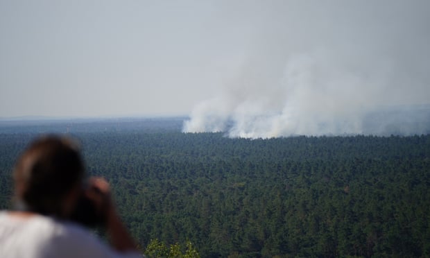 Smoke rises during a forest fire in the Grunewald district of Berlin. Smoke rises during a forest fire in the Grunewald district of Berlin.