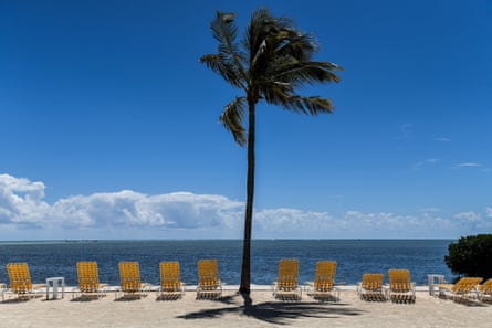Empty lounge chairs line a deserted beach at a resort in Windley Key on 22 March.