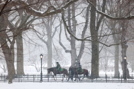 Park enforcement officers patrol on horses in New York's Central Park on Friday in snow