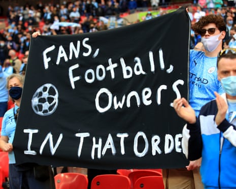 Manchester City fans hold up a banner protesting against the European Super League ahead of the Carabao Cup Final at Wembley