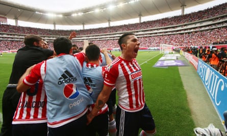 Players of Guadalajara celebrate after scoring against Atlas