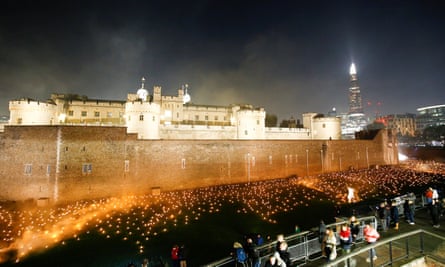Thousands of torches light up the moat of the Tower of London.