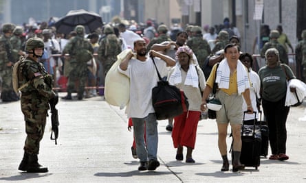 Members of the National Guard help Hurricane Katrina victims evacuate from the convention center in New Orleans on 3 September 2005.
