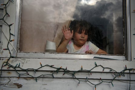 Dolores Mendoza’s niece, 6-year-old Karmen Aleman, stares out the window as her family loads a moving van outside their home in Houston, Texas, on 29 March 2022.