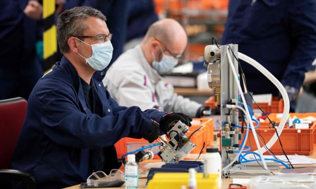 Peugeot-Citroen staff assemble parts of medical ventilators in Poissy, France.