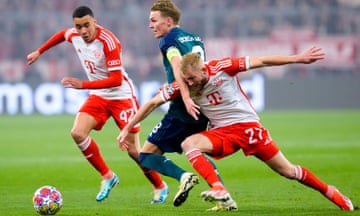 Arsenal's Martin Odegaard (centre) battles for the ball with Bayern Munich's Jamal Musiala and Konrad Laimer.