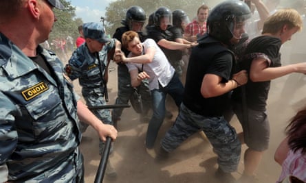Police push a gay rights activist at a gay pride event to prevent clashes with anti-gay protesters at the Marsovo Field in St Petersburg Russia 29 June 2013.