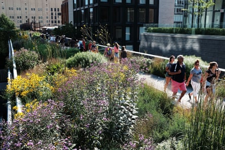 People walk along the plant-filled New York High Line