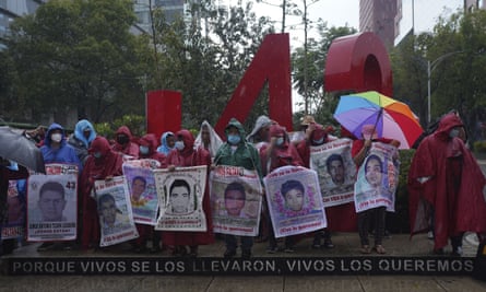 Friends and relatives seeking justice for the missing 43 Ayotzinapa students gather round a monument dedicated to the students during a demonstration in Mexico City lasts month.