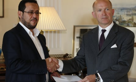 The British ambassador in Turkey, Dominick Chilcott (right) hands over a letter of apology from the UK government to Libyan dissident Abdel Hakim Belhaj