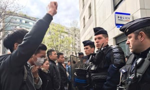 French police face off with members of the Chinese community during a protest outside a police station in Paris