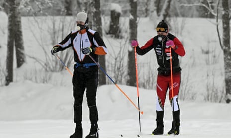 Cross-country skiers wearing breathing masks are seen on the tracks of Oittaa skiing park in Espoo, Finland.