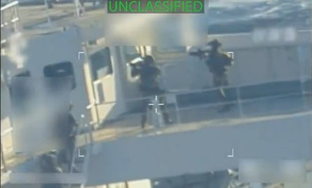 Venezuela Decries ‘Act of Piracy’ after US Forces Seize Oil Tanker Off Country’s Coast 3 Screengrab of two armed people face door on tanker