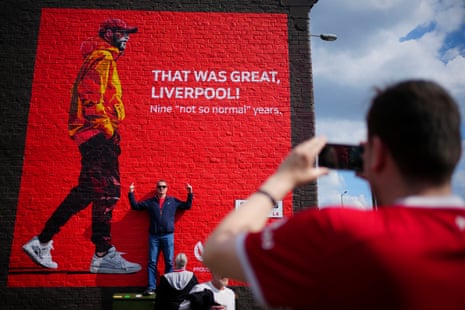 5 May 2024A fan poses for photos next to a mural of Liverpool’s departing manager Jürgen Klopp prior to their match with Tottenham at Anfield. Liverpool won 4-2.