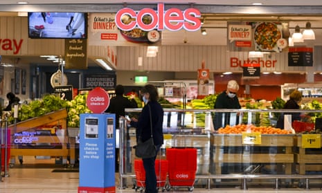A shopper enters a Coles supermarket in Canberra.
