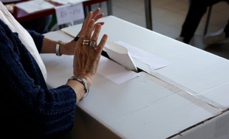 A Romanian woman casts her ballot in the second round of presidential elections at a polling station in Bucharest, Romania.