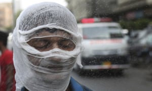 A motorcyclist is sprayed with water by volunteers to help prevent a heat stroke in Karachi, Pakistan.