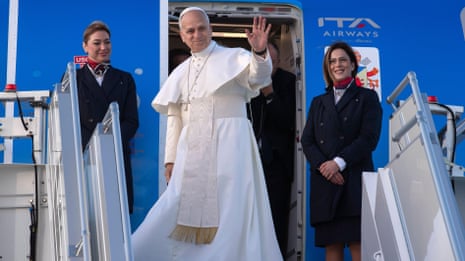 Pope Leo and Recep Tayyip Erdoğan walk on a blue carpet past a military line-up