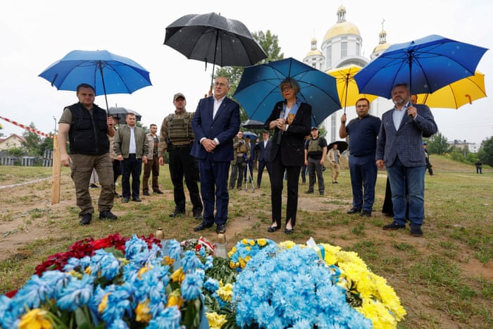 General secretary of the Organization for Security and Co-operation in Europe (OSCE) Helga Maria Schmid and Chairman-in-office and Polish foreign minister Zbigniew Rau visit the site of a mass grave in the town of Bucha.