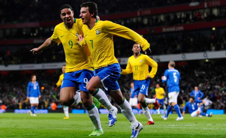 Elano celebrates with Adriano after scoring for Brazil in a friendly against Italy at the Emirates Stadium in 2009
