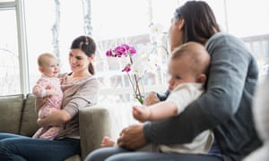 Mothers and babies in a living room.