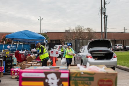 Volunteers distribute food boxes at West Houston Assistance Ministries on 22 March.