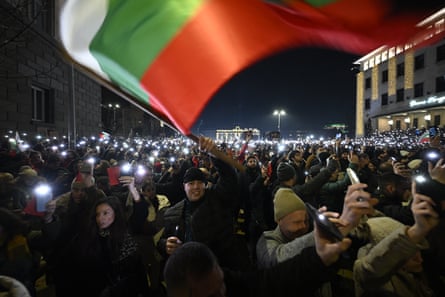 A protester waves the Bulgarian flag at an anti-government protest in Sofia on 10 December.