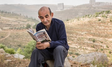 Shehadeh reads his Orwell prize-winning book, Palestinian Walks, outside Ramallah, in the West Bank, 2014.