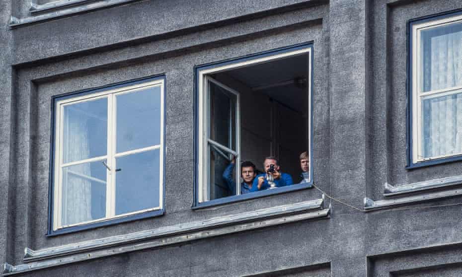 Stasi employees film and photograph a demonstration from an apartment building in East Berlin, 1989.