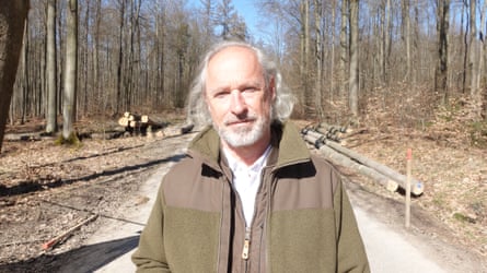 Ralf Paschold, in a forest, looks at the camera